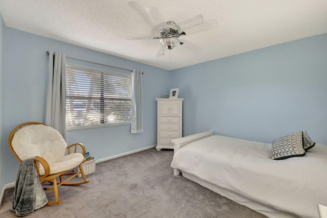 carpeted bedroom with baseboards, a textured ceiling, and ceiling fan