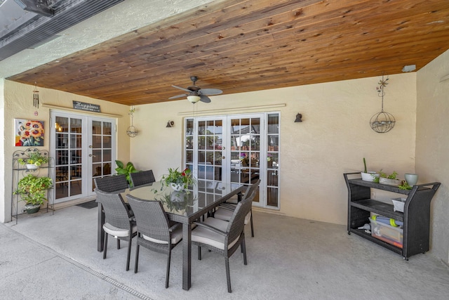view of patio featuring outdoor dining area, ceiling fan, and french doors