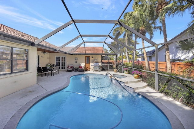 view of swimming pool featuring ceiling fan, a fenced in pool, french doors, a patio, and a grill