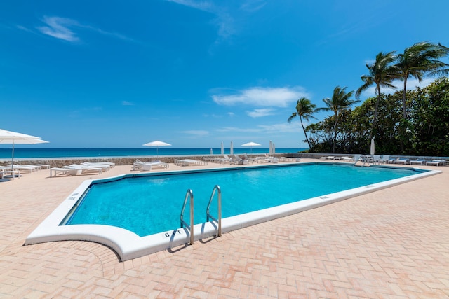 community pool featuring a water view and a patio area