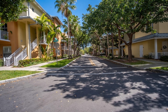 view of road featuring curbs, sidewalks, and a residential view