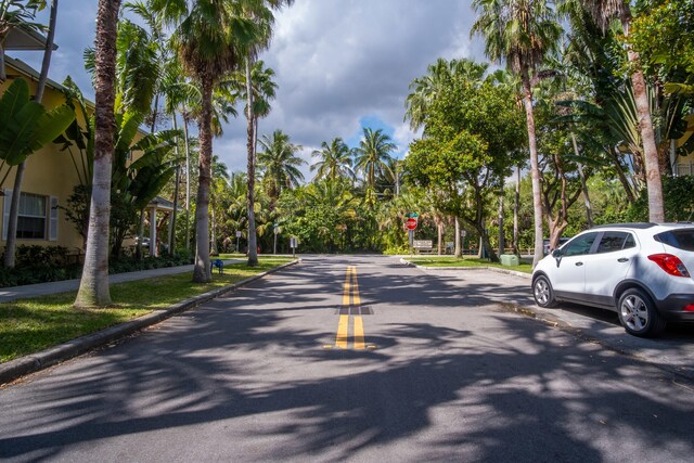 view of road with traffic signs and curbs