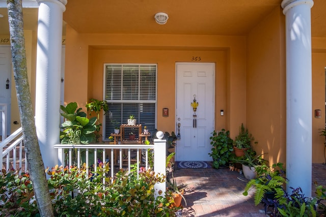 doorway to property featuring stucco siding