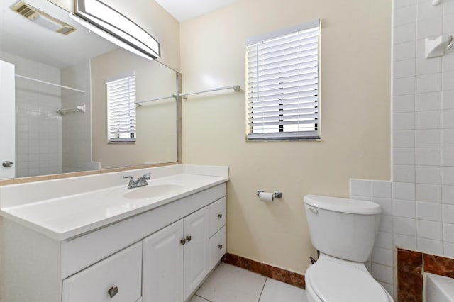 full bathroom featuring vanity, baseboards, visible vents, tile patterned floors, and toilet