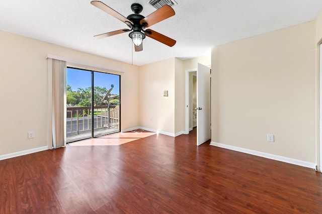 unfurnished room with visible vents, baseboards, wood finished floors, and a ceiling fan