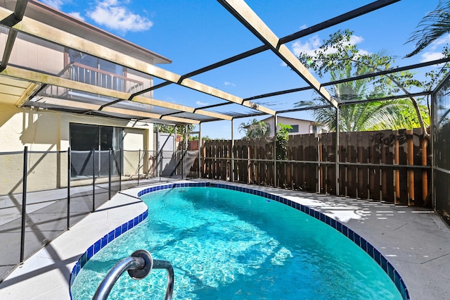 view of swimming pool featuring a lanai, a fenced in pool, a patio, and fence