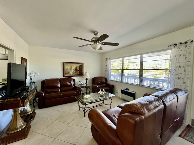 living area with light tile patterned floors and a ceiling fan