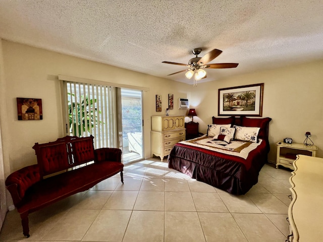 bedroom featuring access to outside, light tile patterned floors, a ceiling fan, and a textured ceiling