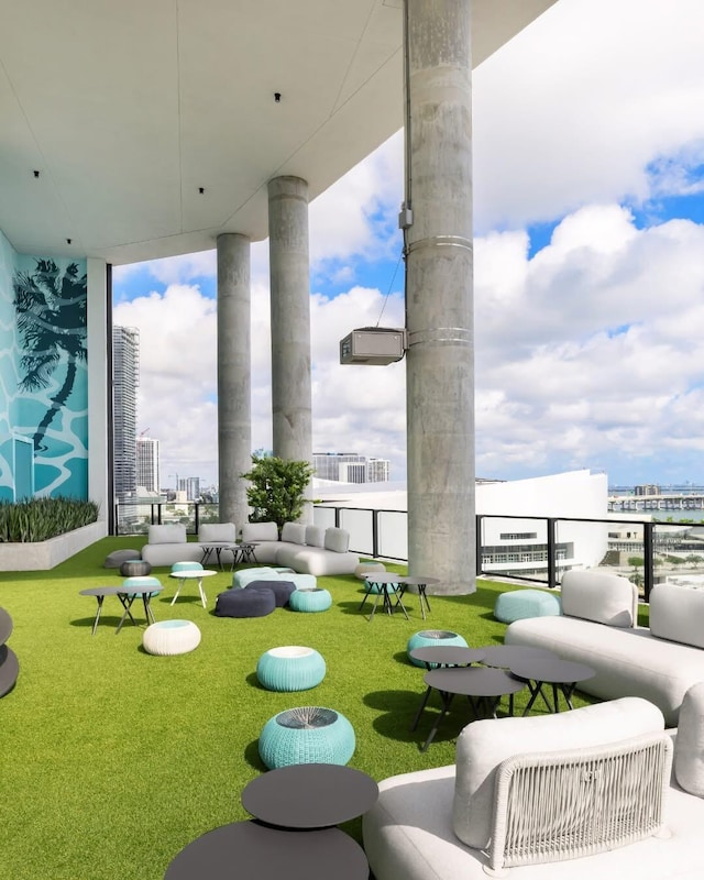 view of patio / terrace with a balcony and a city view