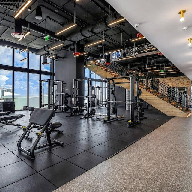 workout area featuring visible vents and floor to ceiling windows