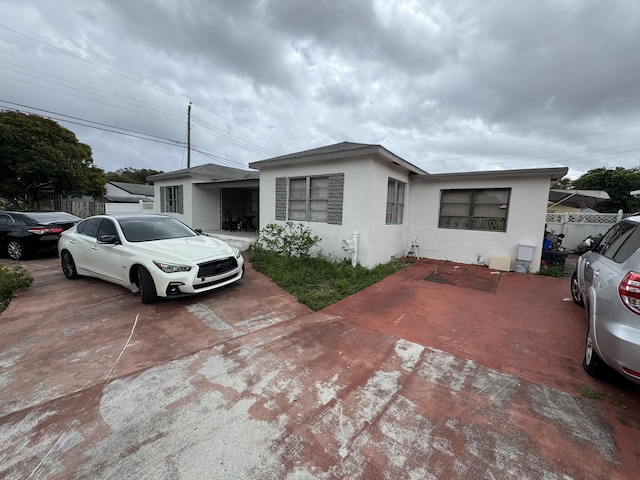 view of front of home featuring fence and stucco siding