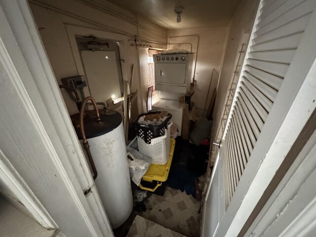 hall featuring gas water heater and stacked washer and clothes dryer