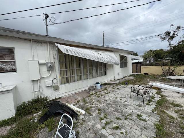 exterior space featuring stucco siding and a patio