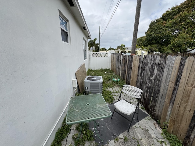 view of patio featuring cooling unit and a fenced backyard