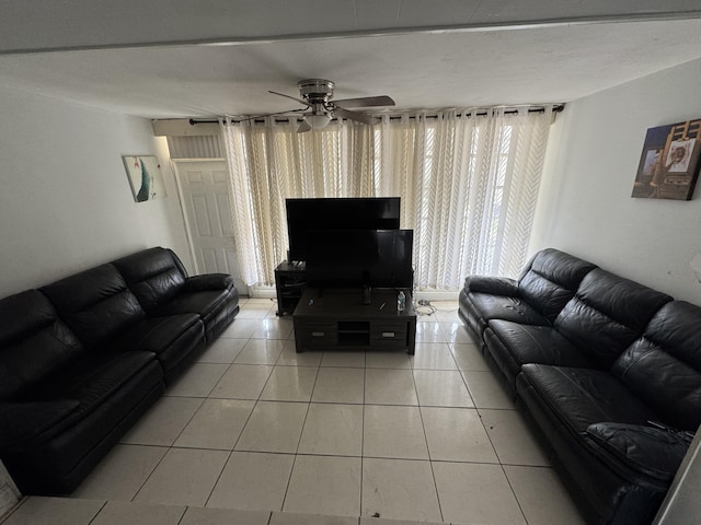 living room with a ceiling fan and light tile patterned floors