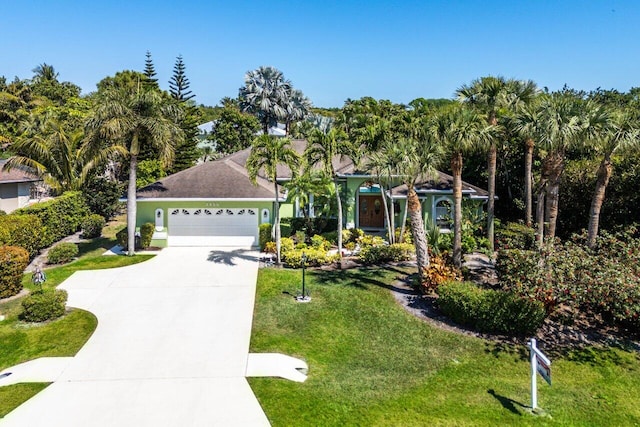 view of front of property with driveway, a front lawn, and a garage