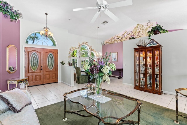 tiled foyer featuring visible vents, ceiling fan with notable chandelier, baseboards, and vaulted ceiling