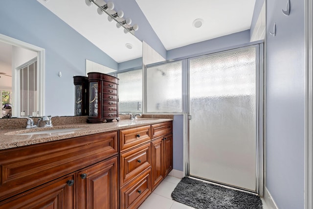 full bathroom with a shower stall, a sink, and tile patterned floors