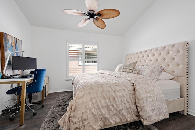 bedroom featuring dark wood finished floors, vaulted ceiling, and baseboards