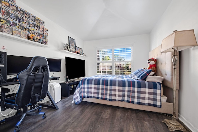 bedroom with baseboards and wood finished floors