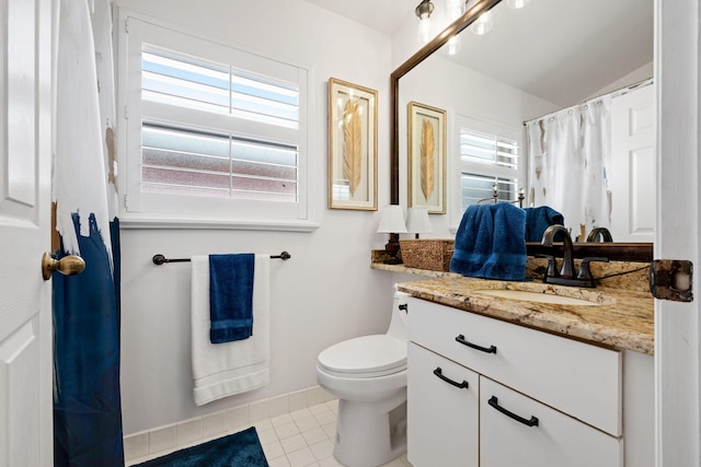 full bathroom featuring toilet, tile patterned floors, plenty of natural light, and vanity