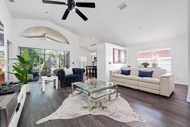 living area with plenty of natural light, visible vents, dark wood finished floors, and baseboards