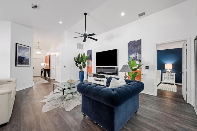 living room featuring dark wood-style floors, high vaulted ceiling, and visible vents