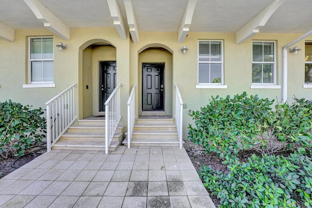 entrance to property with stucco siding