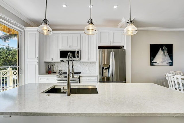 kitchen featuring appliances with stainless steel finishes, pendant lighting, ornamental molding, and tasteful backsplash