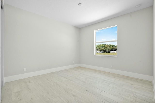 unfurnished room featuring wood finished floors and baseboards