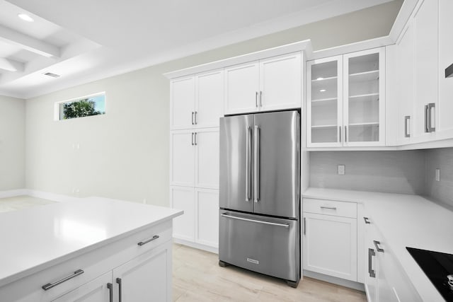 kitchen with light countertops, visible vents, glass insert cabinets, freestanding refrigerator, and white cabinets