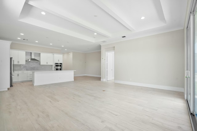 unfurnished living room with crown molding, baseboards, beamed ceiling, and light wood finished floors