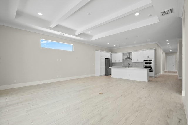 unfurnished living room with recessed lighting, visible vents, baseboards, light wood-style floors, and beam ceiling