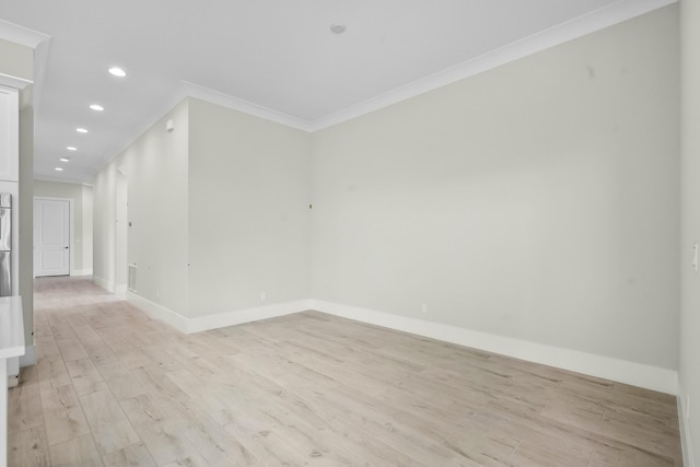 empty room with visible vents, baseboards, crown molding, light wood-type flooring, and recessed lighting