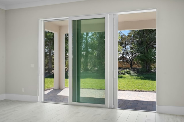 entryway with a wealth of natural light, baseboards, and wood finished floors