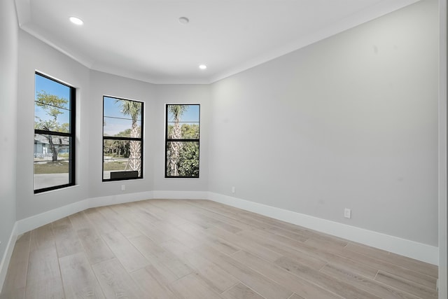 empty room with light wood-style flooring, baseboards, and recessed lighting