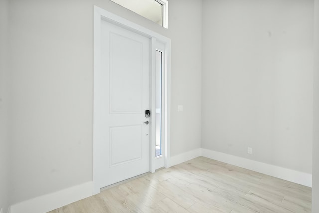 entryway with baseboards and wood finished floors