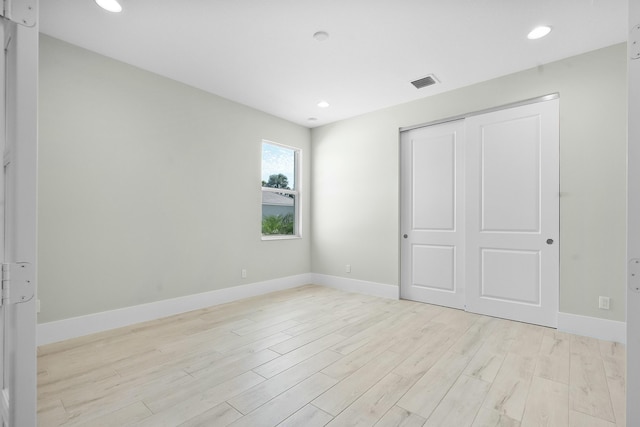 unfurnished bedroom featuring baseboards, recessed lighting, visible vents, and light wood-style floors