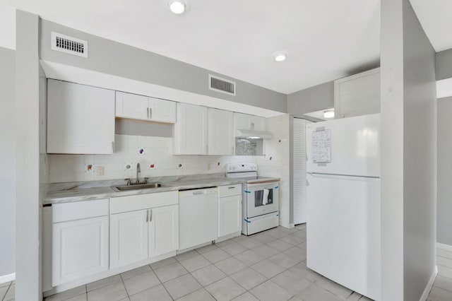 kitchen with white appliances, a sink, visible vents, and white cabinetry