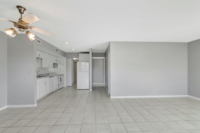 kitchen featuring visible vents, a ceiling fan, white cabinetry, white appliances, and baseboards