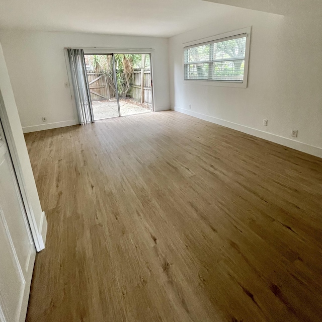 unfurnished room with wood finished floors and baseboards