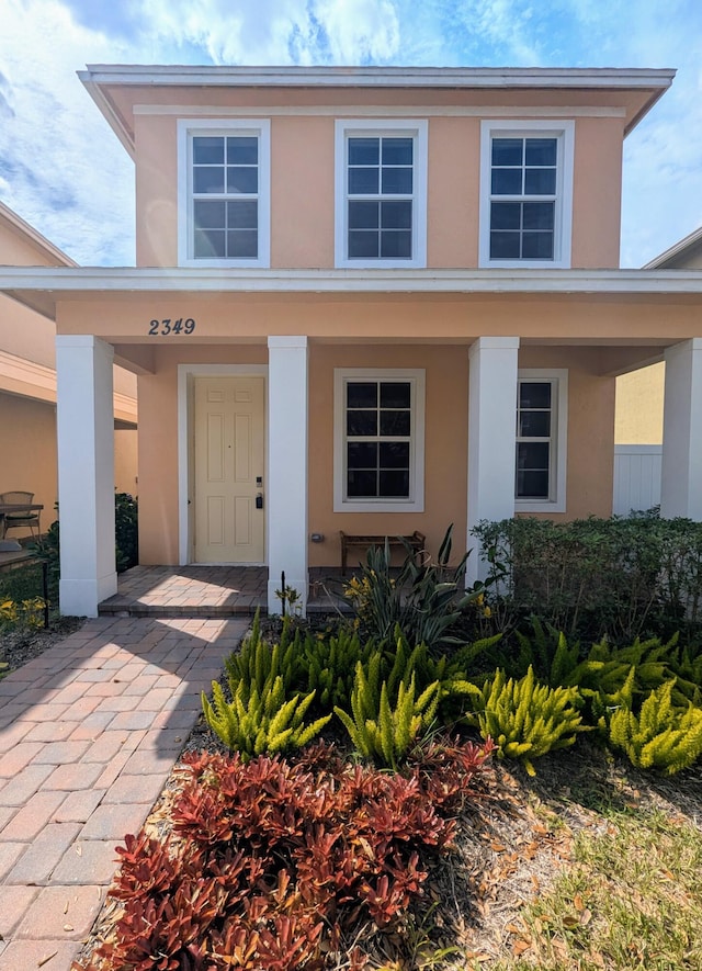 view of front of property with covered porch and stucco siding