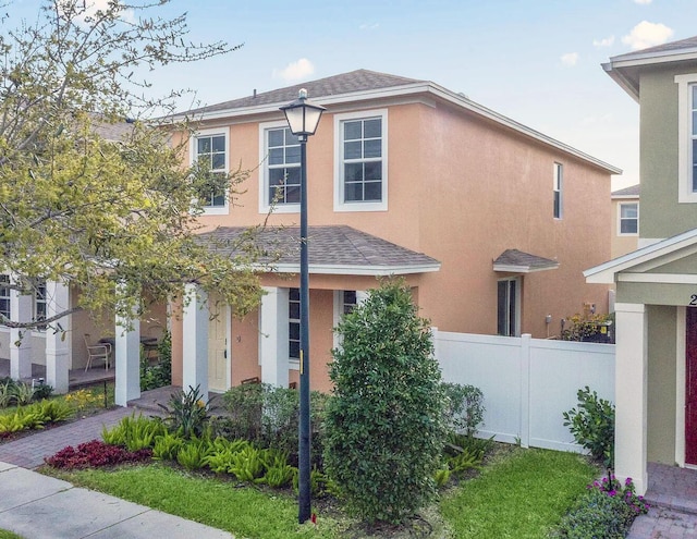 2349 SE Union Park Dr, Port Saint Lucie, FL 34952 - traditional-style house with a shingled roof, stucco siding, and fence