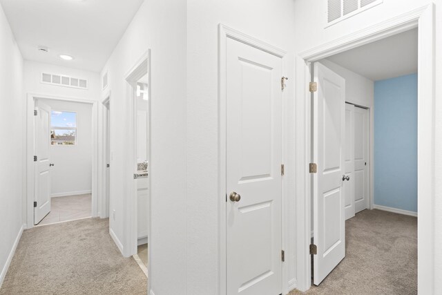 2349 SE Union Park Dr, Port Saint Lucie, FL 34952 - hall with light carpet, visible vents, and baseboards