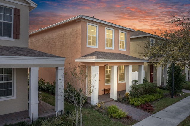 2349 SE Union Park Dr, Port Saint Lucie, FL 34952 - view of front of property with roof with shingles, covered porch, and stucco siding