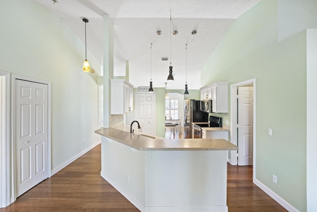 kitchen featuring a sink, range with electric cooktop, white cabinets, high vaulted ceiling, and dark wood-style flooring