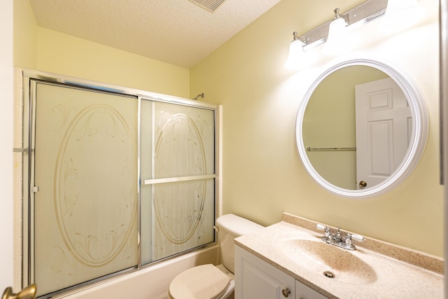 full bath with vanity, visible vents, shower / bath combination with glass door, a textured ceiling, and toilet