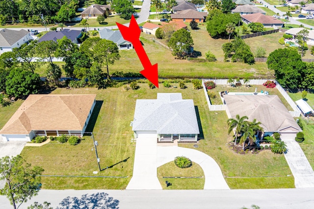 birds eye view of property with a residential view