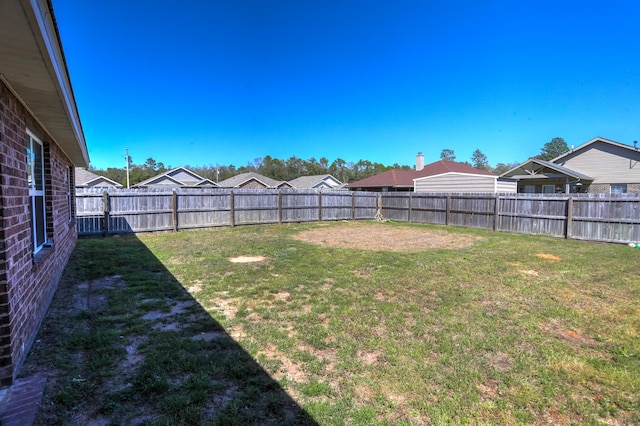 view of yard with a fenced backyard