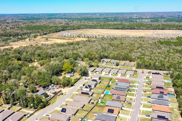 bird's eye view featuring a view of trees and a residential view